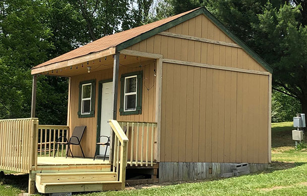Rustic lakefront sleeping cabin rental at Adventure Bound Kamp Modoc
